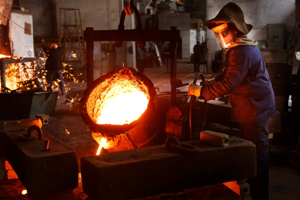 Industrial,Worker,Pours,Molten,Metal,At,Foundry.,Steel,Production,In